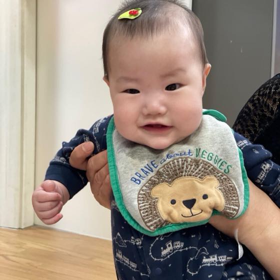 A baby held in an adult's arms