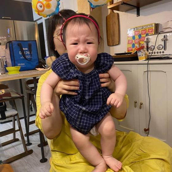 A parent soothing a whimpering baby held in their arms