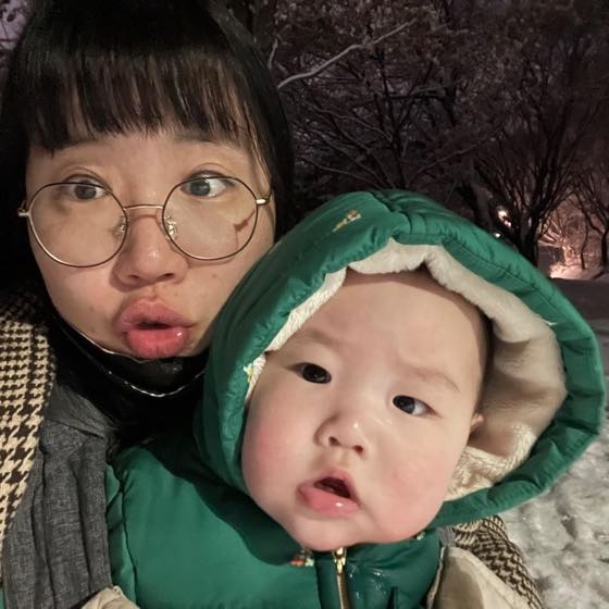 A parent holding a baby and checking on them
